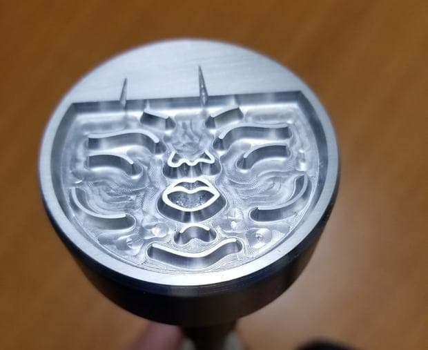 Close-up of a round CNC-machined aluminium stamp head