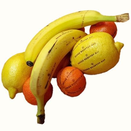 Bananas, lemons and oranges branded with the Sense Rooftop Bar logo